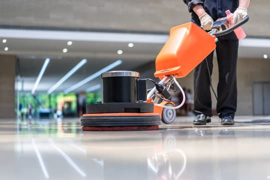A City Shine technician cleaning a floor